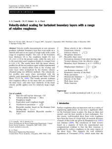 Velocity-defect scaling for turbulent boundary layers with a range