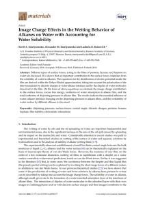 Image Charge Effects in the Wetting Behavior of Alkanes on Water
